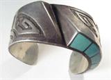 Jewelry Large Sterling & Turquoise Cuff Bracelet
Gorgeous sterling silver cuff bracelet featuring Southwestern style engraving across the wide / thick band, pale green stones inlaid in graduating square designs, possibly green turquoise, on the top and bottom of the band. A unique design, this cuff measures 5.25" long with 1.25" opening, 1.5" wide.
Total weight: 3.02 ozt