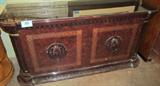 Furniture Lacquer Finish Buffet w/ Glass Top
A beautiful large 2 door Oriental style buffet / sideboard. This item has a gorgeous lacquered finish and a glass top. Ornately carved molding and gold trim accents add to the elegance of the piece. Hinged front doors open to underneath storage. Has a few minor scratches and the top glass has a crack in the left rear corner. Measures 33" tall x 67" across x 21" in depth.