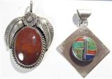 Jewelry Lot of 2 Sterling Pendants w/ Coral & More
Two beautiful Southwestern style necklace pendants:
- Sterling silver square pendant turned on its side, with a circle in the center housing inlaid turquoise, coral & more arranged into a Southwestern style pattern. Wide chain route to accommodate many different size chains, marked / signed "LDG Sterling".
- Breathtaking sterling silver pendant featuring a large red stone, possible apple / sponge coral, polished, fixed in a saw tooth setting surrounded by two large leaves & an intricate rope design. Unsigned, but consignor confirms it to be sterling silver.
Total weight: 0.64 ozt
ZB152