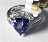 Jewelry 14K White Gold Tanzanite & Diamond Ring
Absolutely stunning 14KT white gold, Tanzanite & diamond ring fitting a finger size 7.5. Included AIG Pre-Sale Gemological Report reads:
"One electronically tested 14KT white gold ladies cast Tanzanite and diamond ring with a bright polish finish. Condition is new, good workmanship. The featured Tanzanite is set within a diamond bezel supported by diamond set shoulders and completed by a two and one-half millimeter wide band. Trademark is ORRIANE. Identified with markings of '14K'. Containing:
One prong set triangle mixed cut natural Tanzanite measuring 9.30 x 9380 x 5.50mm, approximate weight of 2.65 ct., clarity is eye clean, type I, medium, very slightly grayish, violetish blue color, (GIA vB 5/3) to medium, very slightly grayish, purple (GIA P 5/3), cut is good. Transmitting light with no distorton, transparent. The stone displays 40% extinction. Graded in setting.
Tanzanite is a very rare gemstone found only in the country of Tanzan