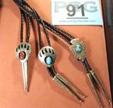 Jewelry 3 Bolo / Bola Tie w/ Turquoise & Coral
Lot of 3 Wonderful Southwestern style bolo / bola ties, each with unique & individual slides:
- One bear claw shadow box housing an irregularly shaped polished red coral, unsigned but confirmed sterling silver by consignor.
- One arrowhead shaped sterling silver slide with a polished turquoise, naturally occurring brown characteristics throughout, with engravings on the silver, marked / signed "Sterling ML".
- One bear claw shadow box housing a polished turquoise stone. Unsigned, confirmed sterling silver.
All three bolo / bola ties have sterling silver tips with engravings at the top of each tip. Ties each measure 18.75" long.
Total weight: 1.93 ozt