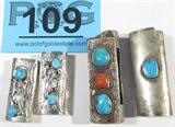 Jewelry 4 Silver Turquiose & Coral Lighter Cases
Lot of 4 Southwestern style lighter cases:
- Two beautiful sterling silver lighter cases, each featuring two round shaped polished turquoise stones with small naturally occurring characteristics throughout, in individual saw tooth settings. Stones are fixed opposite one another with floral / leaf designs in between, Southwestern style engraving / imprinting on the back of the case. Marked / signed "Sterling", both cases measure 2" long.
- Wonderful sterling silver lighter case featuring a single polished turquoise, irregularly shaped, naturally occurring brown characteristics around the edges, fixed in a platform setting surrounded by a rope design. Similar rope design trailing the length of the case on the back. Unsigned, confirmed by consignor to be sterling silver. Measures 2.75" long.
- Gorgeous sterling silver lighter case featuring a square polished coral stone, naturally occurring dark characteristics throughout, and two turquoi