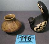 Lot of 2 Southwestern Pottery Sculpture & Vase
Lot of 2 southwestern style pottery pieces. Lot includes:
- An unusual dark brown pottery bird sculpture. Signed "Garcia V". Measures approximately 5.75" tall.
- A small brown bowl or vase with designs which appear to be hand painted. Bottom has a paper label "Made in Mexico" and is signed "Toya Elra". Piece has a few very small dings but is still quite beautiful. Measures 3.25" tall with a 4" diameter.