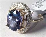 Jewelry 14K Yellow Gold Tanzanite Diamond Ring AIG
A breathtaking 14KT yellow gold Tanzanite & diamond ring fitting a finger size 7.25. Included AIG Pre-Sale Gemological Report reads:
"One electronically tested 14KT yellow gold ladies cast Tanzanite and diamond ring with a bright polish finish. Condition is new, good workmanship. The featured Tanzanite is set within a diamond bezel, completed by a millimeter wide band. Trademark is ORIANNE. Identified with markings of '14K'. Containing:
One prong set oval mixed cut natural Tanzanite, measuring 12.00 x 9.70 x 6.31mm, approximate weight of 5.11ct., clarity is eye clean, type I, medium, very slightly grayish, blue color (GIA B 5/3) to medium, slightly grayish, violet (GIA V 5/2), cut is good. Transmitting light with no distortion, transparent. The stone displays 40% extinction. Colored Stone Grading Report attached. Graded in the setting.
Tanzanite is a very rare gemstone found only in the country of Tanzania. Originally discovered in 19