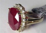 Jewelry 14kt Yellow Gold Ruby & Diamond Ring
Stunning 14kt yellow gold ring featuring a large ruby stone and diamonds. Included GLA Premium Appraisal reads: "One lady's polished, stamped and electronically tested solid 14kt yellow ring mounted with: 1 Genuine Ruby (Corundum) and 18 genuine round full diamonds. This item weighs 9.11 grams and fits a finger size 5.50. The setting measures 19.70 x 17.28mm and the band measures 3.66mm tapering down to 2.82mm at the center of the shank. The condition is brand new. The gemstones have been analyzed in the mounting.
Main Gemstone:
Identity: Genuine Ruby (Corundum)
Shape: Oval (faceted)
Measurements: 15.15 x 13.11 x 8.50mm (est.) (avg.)
Quantity: 1
Carat Weight: 15.16cts (est.)
Clarity Type: II=may include eye-visible features
Hue: Blood red
Transparency: Semi-transparent
Tone: Medium
Saturation: Moderate to strong
Polish: 8-Very Good-Excellent
Finish: 8-Very Good-Excellent
Quality: 7-Very Good
Adjacent Gemstone:
Identity: Genuine Diamond
C