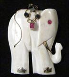 Jewelry Carved Ivory & 14kt Elephant Pendant
A beautiful elephant shaped pendant which appears to be carved ivory. Piece features 14kt gold accents along with several small gemstone settings which appear to be ruby, sapphire and emerald. Measures approximately 1.5" long. A great gift idea for those who believe that having an elephant with the trunk in the up position brings good luck.