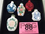 Lot of 5 Vintage Oriental Style Snuff Bottles
Vintage Oriental style snuff bottles:
- Porcelain snuff jar with floral style design, measures 2.75" tall.
- White and blue snuff jar with raised floral design.
- Red snuff jar with oriental style designs, possibly cinnabar, missing topper, brass colored bass has Asian style markings.
- 2 porcelain style snuff jars with oriental style designs.