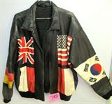 Leather Jacket w/ International Flags
A leather sports jacket with several flag symbols. Countries represented are the United States, Canada, Russia, Korea, Great Britain, Switzerland and more.
Neck label designates the size "L". No manufacturer name. Needs to be cleaned but doesn't appear to have any rips, tears, or holes.