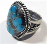 Jewelry Sterling Silver Signed Turquoise Ring
Fabulous sterling silver ring featuring large turquoise stone in saw tooth setting, accented with twisted rope design around stone. Signed, size: 9.75. Total weight: .36 ozt.