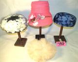 Mixed Lot Vintage Ladies Hats & Wooden Hat Stands
Wonderful mixed lot of vintage ladies hats and hat stands:
- Fabulous hot pink cloche' / turban style hat, with hot pink took / mesh material wrapped around, gold metallic speckles adorning the entire hat, beautiful pink rose applique at the front. Hat bears a tag that reads "Union Made." No size indicated.
- Gorgeous black and white pill box hat, black hat with white silk style flowers positioned all around the hat, black netting over the flowers. No tag or size indicated.
- Fantastic blue feathered pill box style hat with blue netting over the feathers. Feathers are dark and light blue arranged in no particular pattern. Tag reads: "Adele Claire New York", no size indicated.
- Lovely baby pink feather cap with a black elastic chin strap. Feathers are falling apart, shows signs of wear and age. One size fits all.
- Three wooden hat stands measuring 11" tall each.