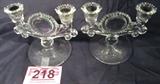 Pair of Vintage Double Light Glass Candlesticks
A pair of lovely clear glass double light candlesticks. The round bottom base features an etched fern design on the underneath side. The glass flume style stem has a unique sunflower like design between the two candle holders. Measures 6" tall x 6.5" wide with a 5" base diameter.