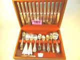 Mixed Lot Silver Plate Flatware & Wooden Chest
A mixed lot of silverplate and sterling flatware which is presented in a velvet lined wooden chest. Lot includes:
- 12 dinner knives, marked Overstreet, Hoopeston, ILL, each measures 8.5" long.
- 14 dinner forks, marked Overstreet. Measures 7.25".
- 12 teaspoons marked 1865 H. Sears & Son. Measures 6.25".
- 11 salad or desert forks. Eight are marked Rogers AA. Each measures approximately 6".
- 17 teaspoons, assorted marks. Each measures approximately 5.75".
- 2 sugar spoons, different marks.
- 2 gravy ladles, one Rogers and one Wallace. Each measures approximately 7" long.
- 1 butter knife, marked Community Plate, Measures 7".
- 9 assorted serving spoons, ladles and a fork. Four are marked Community Silver, triple plate.
