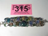 Jewelry .950 Silver Bracelet + Many Colored Stones
Outstanding sterling silver toggle bracelet featuring many different stones of varying shape, cut and color, including but not limited to tourmaline, shell, possibly malachite, & two small geo - style stones. Some are polished and others are nugget style. linked together by chains and welding, marked / signed "Mexico 950". A beautiful and eclectic piece for any jewelry collection.
Total weight: 2.97 ozt