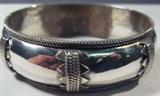 Jewelry Sterling Silver Hinged Bangle Bracelet
Fabulous sterling silver hinged bangle bracelet with Southwestern style designs. Unmarked, consignor states this piece is sterling. Total weight: 1.33 ozt.