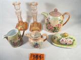 Mixed Lot Glass Candlesticks / Teapot & More
A beautiful lot of decorative glassware items which include:
- A pretty pair of pink molded glass candlesticks. They each measure 9" tall.
- The following glass items are each hand signed "Dina" and all have a similar color and flower pattern:
Teapot, measures 8" tall with lid in place.
A small teapot, perhaps for an individual serving, measures 5.5" tall with the lid in place.
A small open top cream pitcher, measures 4.75" tall.
A covered butter dish, measures 3" tall and 7" long.