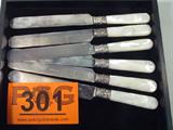 6 Knives Towle Sterling / Mother-of-Pearl Handles
A very beautiful lot of 6 butter knives. The stainless steel blades are marked A. F. Towle & Sons. Between the mother-of-pearl handles and the blades is a band of sterling silver. Each measures approximately 8" long.