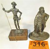 Lot of 2 Cast Metal Warrior Figurines
This lot contains two cast metal figurines which would make lovely decorative pieces:
- A Don Quixote style figurine which stands on a wooden base. Measures approximately 7" tall.
- A vintage cast metal robed warrior figurine. Warrior is holding a sword or saber. Measures 6" tall.