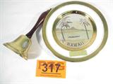 Lot of 2 Brass Bell & Chokin Art "Hawaii" Plate
A beautiful lot of decorative items includes:
- A souvenir plate from Hawaii which is beautifully decorated by the Dynasty Gallery using the art of Chokin. Chokin is the ancient Japanese art of engraving copper and gilding it with precious gold and silver. Plate is 7.75" in diameter.
- A brass color bell with a wooden handle made for the United States Bicentennial by Virginia Metalcrafters. Bell measures 7.5" tall.