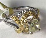 Jewelry 18kt White Gold Yellow Diamond Ring
Gorgeous 18kt white gold yellow diamond ring, size: 6.75. Included AIG Pre-Sale Estimated Retail & Gemological report reads:"One electronically tested 18kt white gold ladies cast diamond ring. Condition is new, good workmanship. The featured diamond is supported by intertwined ribbons of diamonds, completed by a three millimeter wide band. Bright polish finish with yellow gold accents and milgrain detailing throughout. Identified with markings of "18k". Containing:
One prong set cushion cut diamond, measuring 5.80 x 5.70 x 3.53mm (depth est.) approximate weight of 1.14ct with a strong blue fluorescence. Graded in the setting.
Clarity: I-1
Color: Fancy Light Yellow
Depth: 61.9%
Table: 64.9%
Fifty prong set round brilliant cut diamonds, measuring 1.00 - 0.80 x 0.54mm (depth est.) approximate total weight of 50 stones = 0.21ct. The group is composed of a mix of natural fancy yellow color diamonds and irradiated fancy yellow color diamonds. Gra