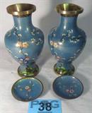 Matching Pair of Cloisonne Style Vases
A beautiful pair brass color metal vases which appear to have a painted enamel Cloisonne finish. The flower design features red, blue, green and pink colors. Lot also includes a pair of small matching plates. The plates are 3.5" in diameter. The vases are approximately 9" tall. One vase is dented on the top rim.
Z14