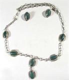 Jewelry Sterling Silver Malachite Necklace Set
Gorgeous sterling silver necklace and earrings set with Southwestern style design. "Y" shaped necklace featuring 6 oval shaped polished malachite stones, measures: 19" long. Matching clip on earrings with malachite stones. All pieces marked "sterling", total weight: .96 ozt.
ZB152