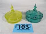 Lot of 2 Depression Glass Candy / Preserve Dishes
This lot contains the following vintage depression glassware:
- A greenish yellow vaseline glass candy or preserve dish with a lovely spiral design lid. Dish measures 3.5" tall with the lid in place and has a 4" diameter.
- A second identically shaped dish which is a deeper green color and appears to have a hand painted floral design on the lid. The measurements are identical.