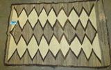 Hand Woven Native American Indian Wool Rug
A brown and beige diamond design wool rug. Consignor states that it was purchased at an Indian Reservation. Rug has a small area that has been repaired and there are other areas where the material is very worn. Measures 51" x 36"