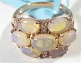 Jewelry Sterling Silver Ethiopian Opal Ring
Gorgeous gold washed sterling silver fashion ring featuring 7 oval shaped, prong set, Ethiopian opal stones and small round diamond stones. Ring size: 6, total weight: .10 ozt.