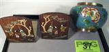 Mixed Lot Cloisonne Bowl & Wooden Bookends
Lot includes:
- A pretty copper color bowl which appears to have an enamel finish featuring a blue green background with a lovely floral design. Measures 4.5" tall.
- A pair or Oriental style bookends featuring a decorative pattern on each which includes opalescent and matte finish materials. Each bookend measures 5.5" tall.