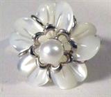 Jewelry Sterling Mother of Pearl Flower Ring
Gorgeous sterling silver ring with lovely flower design, petals are possibly Mother of Pearl. Center of flower is accented with a pearl. Marked "925", ring size: 8.5. Total weight: .11 ozt.
