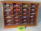 NASCAR Wooden Display of 24 Die Cast Race Cars
This wonderful adult collectible NASCAR collection features 24authentically scaled die-cast replica cars in a very nice wooden display case with a plexy-glass front. Various manufacturers include Hot Wheels, Racing Champions and Action Performance. Cars are dated in the 1990's and early 2000s. Sponsor logos include Pepsi, Mountain Dew, Big K-Mart, Parts America, and more. A few of the Cars included in this lot are NASCAR numbers 11, 17, 66, and 88.