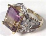 Jewelry 10kt Yellow Gold Ametrine Fashion Ring
Gorgeous 10kt yellow gold ring with large purple and yellow colored prong set stone, consignor states this gemstone is Ametrine. Band is accented with several small Cubic Zirconia stones. Marked "10k", ring size: 8.25. Total weight: 3.3 dwt.