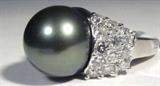 Jewelry 14K White Gold Tahitian Pearl Diamond Ring
Fabulous 14KT white gold & Tahitian cultured pearl ring with diamond shoulders. Included AIG Pre-Sale Estimated Retail & Gemological Report states:
"One electronically tested 14KT white gold ladies cast Tahitian cultured pearl and diamond ring with a bright polished finish. Condition is new, good workmanship. The featured Tahitian cultured pearl is supported by diamond set shoulders and completed by a two millimeter wide band. Identified with markings of "K14". Containing:
- One black Tahitian cultured pearl, 14.0mm in size. The pearl is black in color with a high luster, hick nacre, mostly round, lightly spotted. Grade in the setting. Tahitian cultured pearls form in the large "Black Lipped" Pinctada Margaritifera oyster, which is about twice the size of the Japanese Akoya oyster. This warm water species from across the central and South Pacific Ocean is at home in the bays and lagoons of the islands & atolls of French Polynesia. Tahi