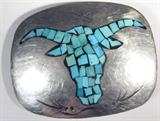 Jewelry Southwestern Turquoise Bull Belt Buckle
Wonderful Southwestern style belt buckle, silver color, with the shape of a bull's head on the front filled with chip style turquoise. Bears a signature / marking on the backside of what looks like a snow capped mountain, possibly a maker's mark. Measures 3" x 2.5",