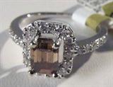 Jewelry 14kt White Gold Fancy Brown Diamond Ring
Gorgeous 14kt white gold ring featuring brown and white diamond stones, size: 7.25. Included AIG Pre-Sale Estimated Retail & Gemological Report reads: "One electronically tested 14kt white gold ladies cast diamond ring with a bright polish finish. Condition is new, good workmanship. The featured diamond is set within a diamond bezel, supported by diamond set shoulders and completed by a one and one-half millimeter wide band. Identified with markings of "14K". Containing:
One prong set emerald shaped cut diamond, measuring 5.90 x 4.80 x 3.85mm approximate weight of 1.08ct with a strong blue fluorescence. Graded in the setting.
Clarity: SI-1
Color: Fancy Brown
Depth: 80.2%
Table: 66.7%
Twenty four prong set brilliant cut diamonds, measuring 1.80 - 1.60 x 1.02 mm (depth est.) approximate total weight of 24 stones = 0.50ct. Graded in the setting.
Clarity: SI-2 to I-2
Color: F - H
Total weight of Diamonds: 1.58 ct
Total weight of ring: 3.6
