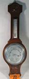 Wilson Banjo Style Barometer & Thermometer
A vintage British barometer and thermometer mounted to a banjo shaped wooden display. Manufactured by the Wilson Company. Barometer has printed settings for "storm, rain, change, fair, very dry" and explains that the barometric pressure falls for wet or more wind and rises for dry or less wind. The thermometer reads in both Fahrenheit and Centigrade. Appears to be in working condition. Measures approximately 26" long.
ZB152