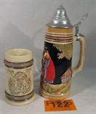 Lot of 2 Vintage German Beer Steins
Lot contains the following items:
- A one liter beer stein, appears to have a pewter thumb lid and features a colorful scene of two men, a women, and a dachshund. Bottom is marked "Original King". Measures approximately 11" tall. No lithophane.
- An open top mug or stein featuring a scene with one gentlemen. Captioned "Zum Wohl". Measures 5.75" tall.
Z14