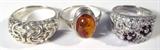 Jewelry Lot of 3 Sterling Silver Rings Amber CZ
Lot of 3 sterling silver ladies fashion rings:
- Breathtaking sterling silver ring featuring several small white stones, possibly Cubic Zirconia, with several small deep red stones, possibly garnet, arranged in small flower arrangements, filigree style design throughout. Marked / signed "925 China 7", fits a finger size 7.0.
- Beautiful sterling silver ring featuring silver swirling filigree style designs throughout, marked / signed " Thailand 925". Fits a finger size 8.25.
- Gorgeous sterling silver ring featuring a smooth amber stone in a bezel setting on a thin silver band. Marked / signed "925", fits a finger size 8.75.
Total weight: 0.60 ozt
#2447-9051-CFSG5300