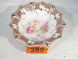 Antique RS Prussia Hand Painted Porcelain Bowl
A beautiful hand painted porcelain bowl, bottom is signed "RS Prussia". Bowl has a scalloped rim and a beautiful purple and gold pattern on the inside rim. Bottom of bowl is painted with a multiple variety of flowers. Measures 3" tall and 11" in diameter.
ZB152