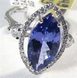 Jewelry 18kt White Gold Tanzanite & Diamond Ring
Fabulous 18kt white gold Tanzanite and Diamond ring. Size: 7.
Included AIG Pre-Sale Estimated Retail & Gemological report reads: "One electronically tested 18kt white gold ladies cast Tanzanite and diamond ring with a bright polish finish. Trademark is HANA. Identified with markings of "18k".Condition is new, good workmanship. Containing:
One prong set marquis mixed cut natural Tanzanite, measuring 14.80 x 7.40 x 4.77mm, approximate weight of 3.43ct., clarity is eye clean, type 1, medium dark, very slightly grayish, violetish blue color, (GIA vB 6/3) to medium dark, moderately strong, bluish purple, (GIA bP 6/4), cut is good. Transmitting light with no distortion, transparent. Graded in the setting.
Tanzanite is a very rare gemstone that is only found in the country of Tanzania. Originally discovered in 1967. Tiffany & Company named the stone Tanzanite. It is found in the Usumburu Mountains that border the Umba Valley of northern Tanza