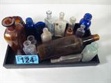 Mixed Lot Vintage Glass Medicine / Tonic / Bottles
This mixed lot of vintage glass bottles contains various sizes, shapes and colors which held tonics and elixirs from days gone by. Lot includes:
- A brown glass liquor / tonic bottle which is embossed "Jos. Triner - Chicago". Measures 10.5" tall.
- A brown glass jar which possibly held a cream or lotion. Jar is embossed Johnson & Johnson, New Brunswick, NJ, USA". Measures 4.25" tall.
- A small light green glass which is embossed, "Hires Household Extract - For Making Rootbeer at Home - Manufactured by the Charles Hires Co. - Philadelphia, PA". Measures 4.25" tall.
- A cobalt blue glass jar embossed "Bromo-Seltzer, Emerson Drug Co., Baltimore, MD". Measures 4" tall.
- A clear glass bottle embossed "Mitchella". Measures 3.75" tall.
- A clear glass bottle embossed "Chamberlain's". Measures 4.75" tall.
- Several other bottles.
ZB2776