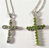 Jewelry Sterling Silver Peridot Cross Necklaces
Beautiful sterling silver religious cross necklaces: 
- Cross pendant made up of several prong set green colored stones, (Peridot) hanging on 17" Figaro style chain. 
- Delicate cross pendant accented with 6 round green colored stones, (Peridot) pendant hangs on 15" chain. 
The consignor states all of these stones are Peridot. 
All pieces marked "925", total weight: .37 ozt. 
ZB1341