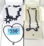 Jewelry Lot of 3 T. Lee Black Fashion Necklaces
Lot of 3 stunning fashion necklaces:
- Gorgeous black polished stone necklace, possibly onyx, in a single strand that terminates with a gold washed hidden hook clasp, measures 24" long. 
- Stunning fashion necklace featuring a large black pearl, secured to a silver, possibly white gold anchor, hangs on a black chord with a 14K white gold clasp marked / signed "14K". Measures 24" long. 
- Magnificent black stone necklace by T. Lee, featuring several black stones, possibly Onyx with a matte finish, pear shaped / tooth style positioned all around the band, complete with a silver colored hook clasp. Measures 20.5" long. 
ZB4841