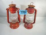 Lot of 2 Railroad / Camping Kerosene Lanterns
This lot contains 2 vintage railroad / camping lanterns:
- An orange / red lantern with a clear glass globe that contains no manufacturer marks. Has a few paint chips and the some rust. Measures 12" tall.
- A red Hope, No. 500 lantern made in Korea. Has a clear glass globe. Item has a few paint chips, some rust, and is splattered with white paint. Measures 12" tall.
ZB2776