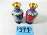 Lot of 2 Cloisonne Miniature Vases
Gorgeous pair of matching miniature Cloisonne oriental vases. One is mainly red with beautiful pink blooming roses, and one is primarily blue with the same style of blooming roses. Each comes with its own small round display stand, and each measures 4.25" tall. 
ZB2776