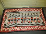 Southwestern Navajo Yeibichai Blanket
Beautiful Southwestern Navajo blanket, "Yeibichai" style design with 10 dancers, 1 "Water Sprinkler" and 1 extra individual, possibly representing a Holy Man. Dancers are profile, each with 1 leg raised as if dancing. Colors included are red, orange, black, grey and white. Red and white border. Blanket is very dirty and has a slight odor, needs cleaning, is also frayed in several places. Measures 94" x 55.5".
Z14
