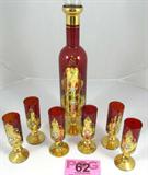 Hand Painted Cordial Decanter & Six Glasses
A beautiful ruby colored glass set which contains a stemmed sherry / cordial decanter and 6 stemmed glasses. Each piece appears to have been hand painted with a beautiful floral design on a gold background. The decanter has a glass stopper. The decanter measures 15.5" tall. Each glass measures 5.25" tall. Some of the paint shows signs of wear and one of the glasses has a small chip on the bottom pedestal.
ZB5022