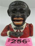 Black Americana Mechanical Bank
Place a coin the man's hand and push a small lever on his back and he will lift his arm to his mouth to deposit the coin. His eyes roll back in unison with the arm movement. Paint shows wear from age and use. There are no manufacturer marks present on the bank which is approx: 6" tall.
ZB4623