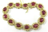 Jewelry 14K Yellow Gold Ruby Diamond Bracelet AIG
Elegant 14K yellow gold, ruby & diamond bracelet. Included American International Gemologists (AIG) Gemological Report reads:
"One electronically tested 14K yellow gold ladies cast & assembled ruby and diamond bracelet. A seven and one-half inch length flexible strap composed of thirteen ruby & diamond florets, terminating in a concealed clasp, with safety. Bright polish finish, with milgrain detailing throughout. Identified with markings of "14K". Condition is new, good workmanship. Containing:
Thirteen prong set oval mixed cut natural rubies, measuring an average of 8.00 x 6.00mm, approximate total weight of 22.77ct., clarity is heavily included, type II, medium dark, moderately strong, slightly purplish red color, (GIA, slpR 6/4), cut is good. Transmitting light with some distortion, translucent. Naturally occurring internal & external characteristics are present. Graded in the setting. 
Indications of laboratory high temperature hea