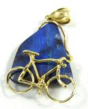 Jewelry 14K Yellow Gold & Opal Bicycle Pendant
Gorgeous 14K yellow gold pendant featuring a natural / freeform blue stone with an opalescent streak running down the center, consignor states this is a natural opal. Yellow gold anchor with a gold bicycle figure at the bottom of the stone. Marked / signed "14K". Measures 1.75" long from the top of the chain route.
Total weight: 4.4 dwt
ZB989